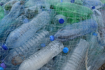 Plastic bottles in fishing net on beach