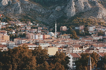 Panoramic view of a city nestled in a mountain valley with a mosque