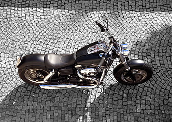 High Angle View of Black Cruiser Motorcycle on Cobblestones
