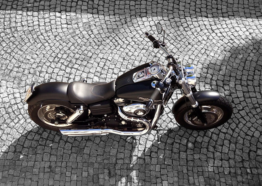 High Angle View of Black Cruiser Motorcycle on Cobblestones