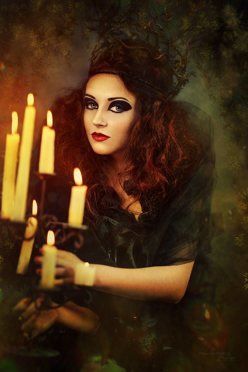 Mystical Sorceress with Candles and Dark Makeup