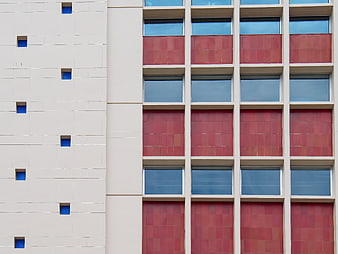 Modern Building Facade with Red Tiles and Blue Windows
