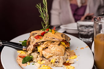 Gourmet Brunch Stack with Rosemary Garnish on White Plate