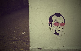 Sticker of smiling man with sunglasses on concrete wall