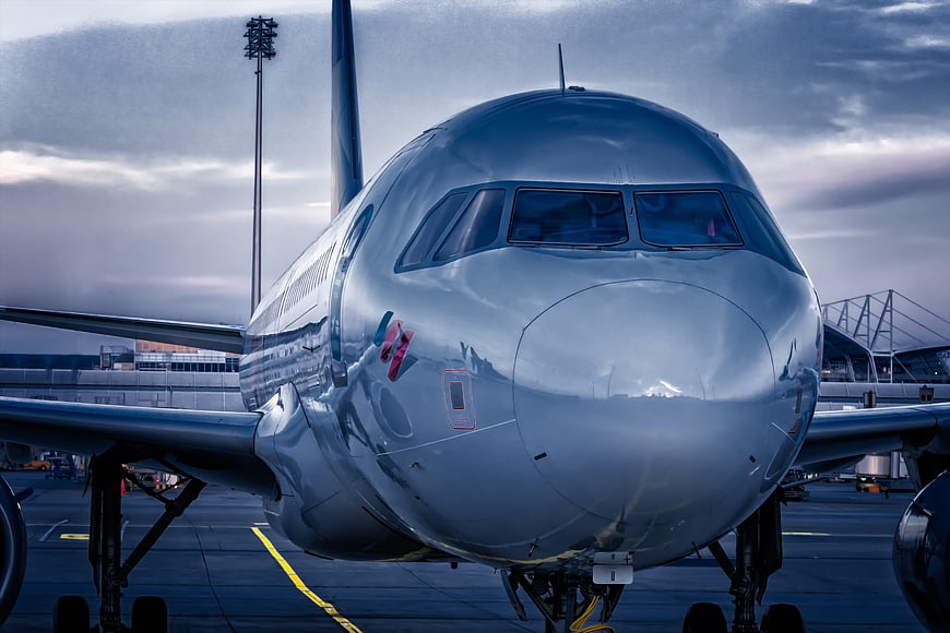 Front View of Commercial Airplane at Airport Terminal During Dusk