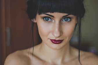 Close-up portrait of woman with dark hair and red lipstick