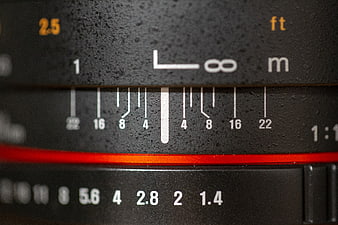 Close-up of vintage camera lens aperture and focus scale