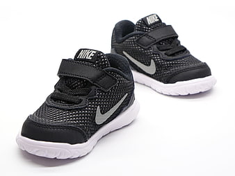 Black Nike Toddler Sneakers With Velcro Straps On White Background
