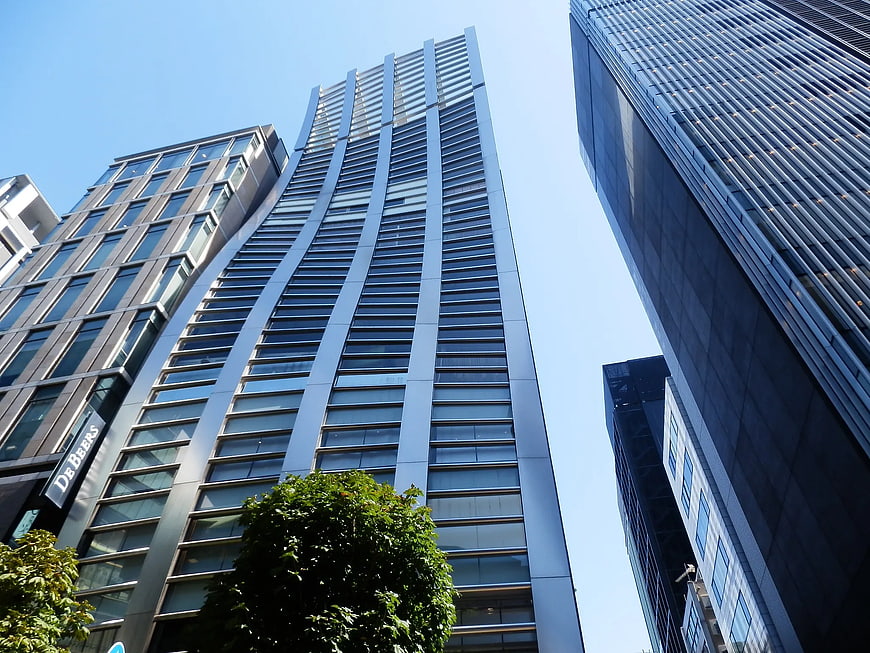 Low angle view of modern skyscrapers against blue sky