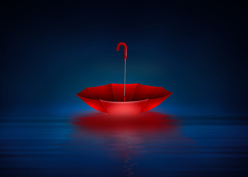 Red Umbrella Floating on Dark Blue Water at Night