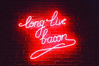 Red Neon Sign Saying Long Live Bacon on Brick Wall