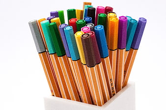Colorful felt tip pens in a white holder