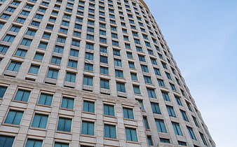 Low angle view of modern curved office building facade