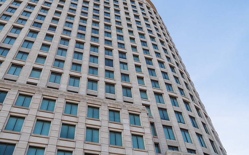 Low angle view of modern curved office building facade