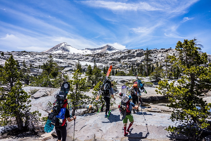 Group of Skiers and Snowboarders Hiking in Rocky Mountains