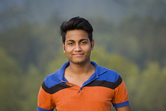 Portrait of a smiling young man in a colorful polo shirt outdoors