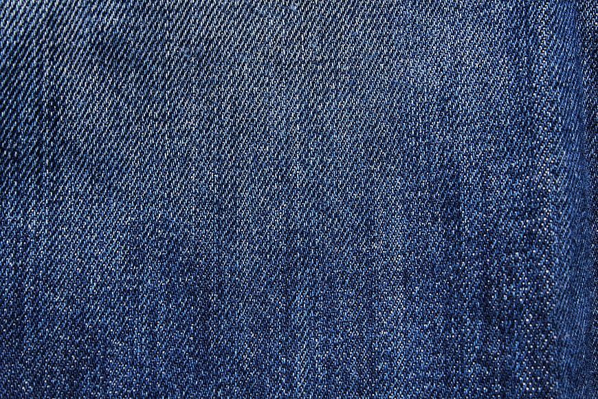 Close-up texture of blue denim fabric weave pattern