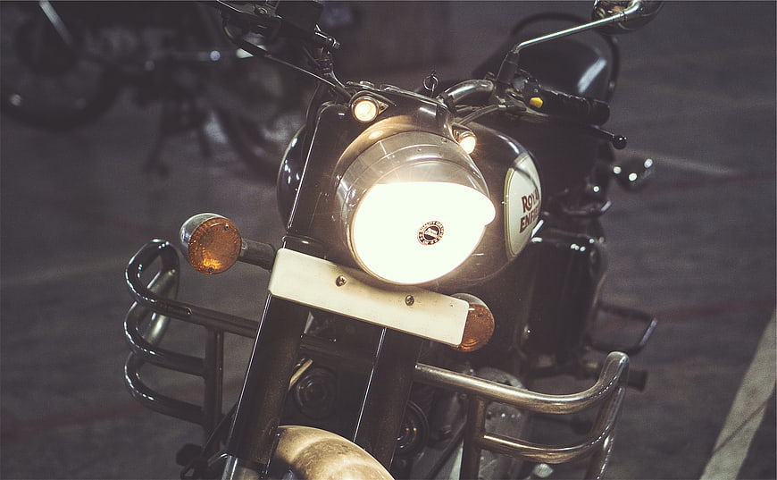 Close-up of Royal Enfield Motorcycle Headlight at Night