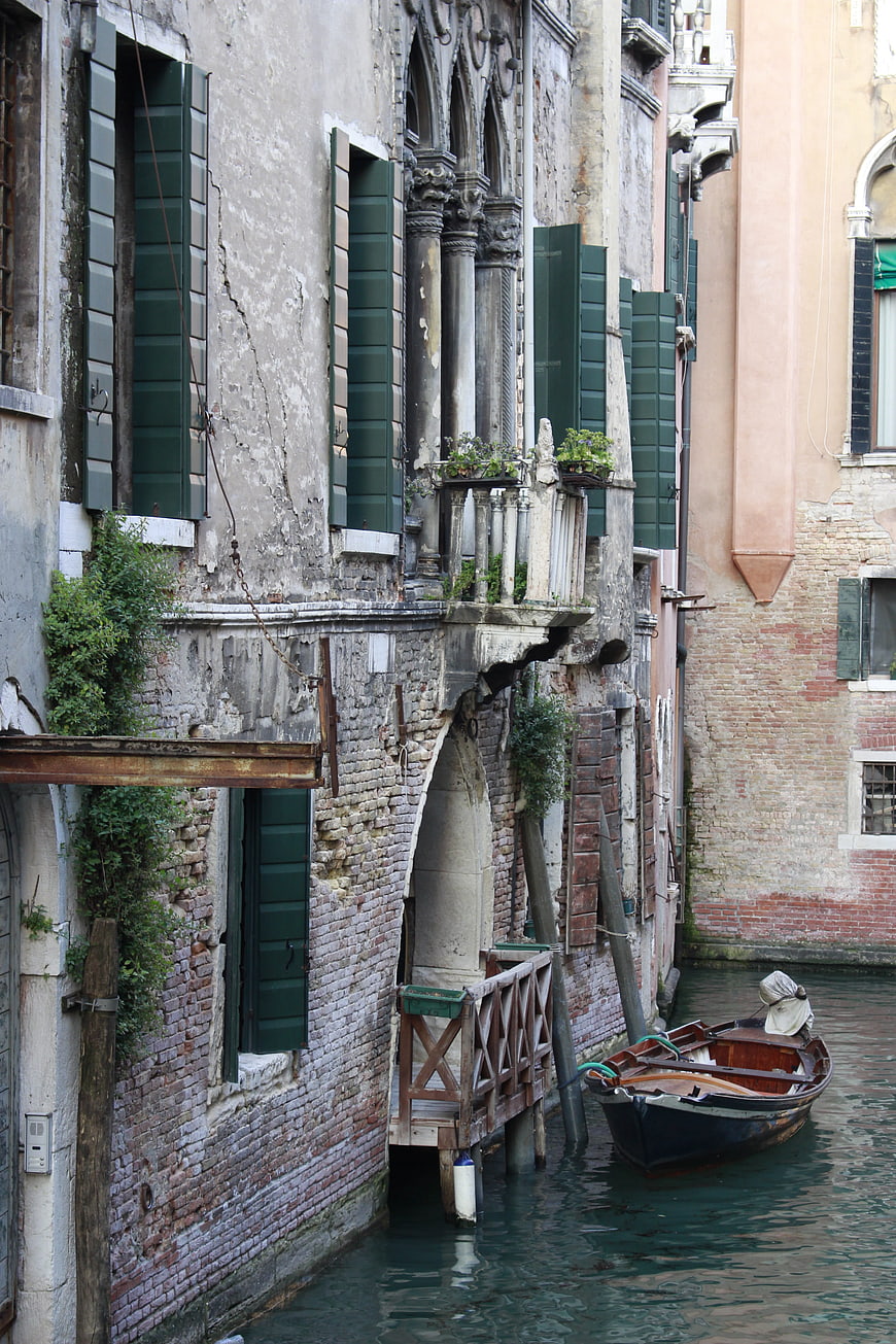 Venetian canal with weathered architecture and moored boat