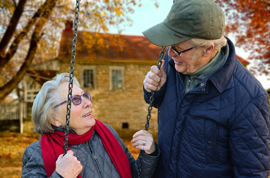 Senior Couple Sharing a Moment on a Swing in Autumn