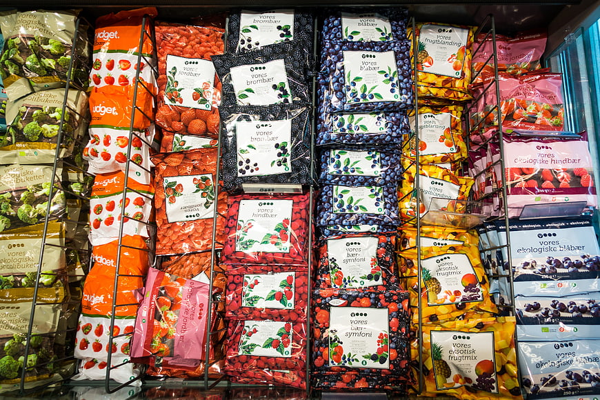 Colorful Frozen Berries and Fruit Display in Supermarket Freezer