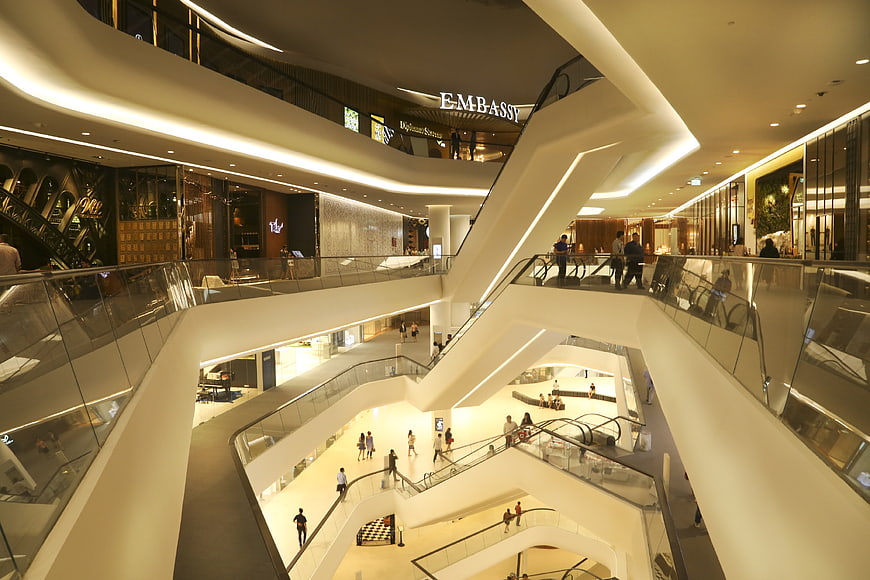 Modern multi-level shopping mall interior with escalators