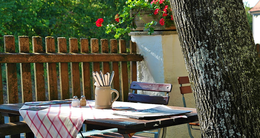 Outdoor beer garden table with cutlery and checkered tablecloth