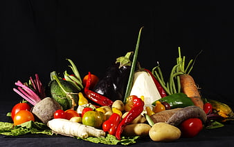 Colorful assortment of fresh vegetables on black background