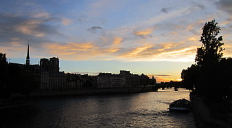 Paris Cityscape at Sunset with Notre-Dame Cathedral Silhouette