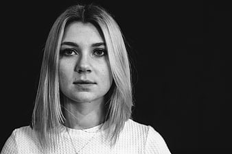 Black and white portrait of young woman looking at camera