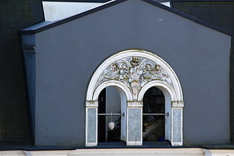 Ornate Arched Window Detail On Gray Building Facade