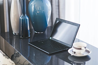 Modern home office desk with laptop and coffee cup