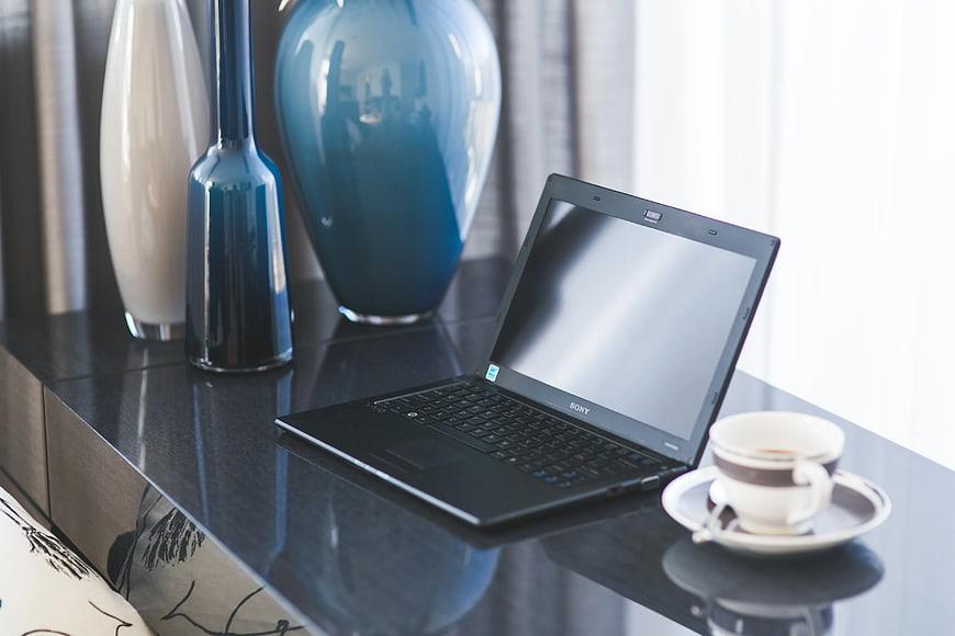Modern home office desk with laptop and coffee cup