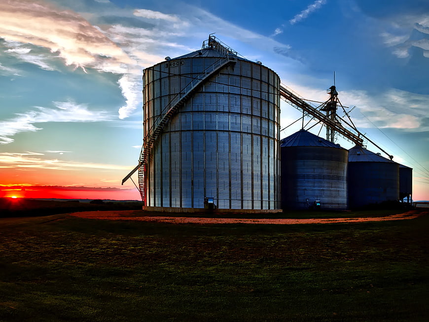 Grain Silos at Sunset in Rural Landscape
