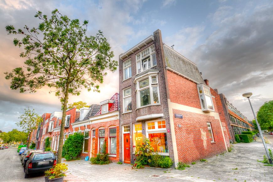 Colorful Dutch brick row houses with dramatic sky