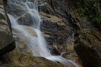 Long Exposure Waterfall Flowing Over Wet Rocks