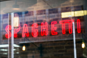 Red Spaghetti Neon Sign in Restaurant Window