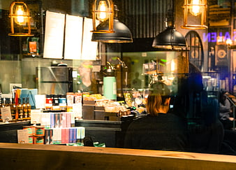 Woman sitting in a cozy cafe at night