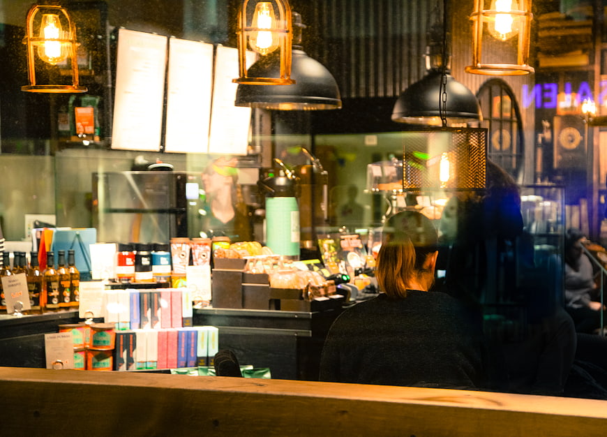 Woman sitting in a cozy cafe at night