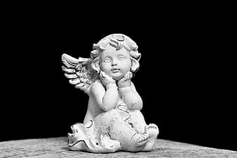 Monochrome Angel Statue Sculpture on Textured Surface