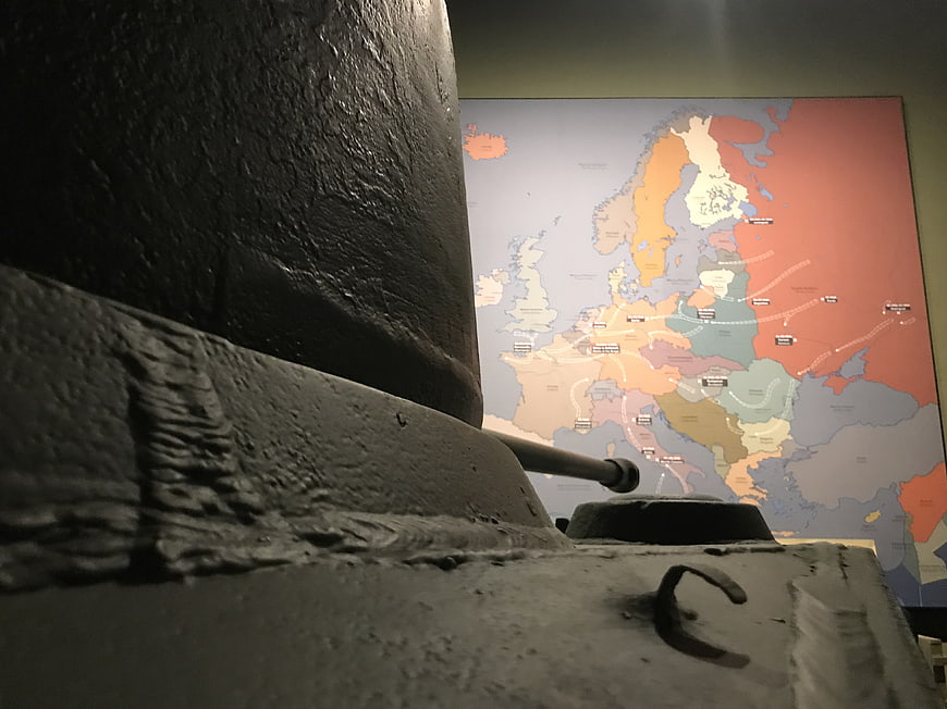 Close-up of WWII tank model with Europe map background
