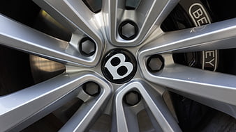 Close-up of silver Bentley car wheel rim with brake caliper
