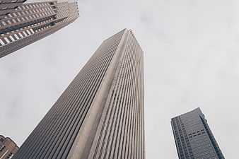 Low angle view of modern skyscrapers against overcast sky