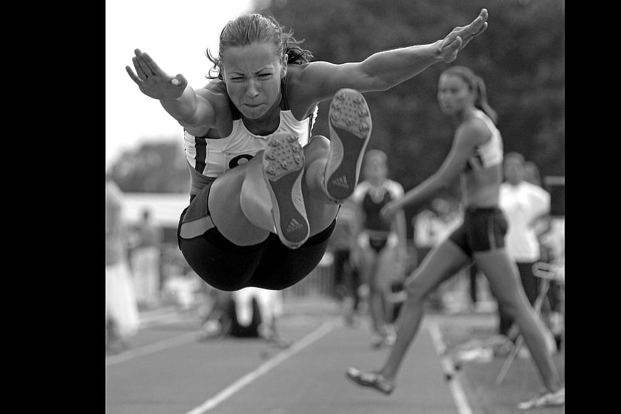 Female Athlete Mid-Air Long Jump Action Shot