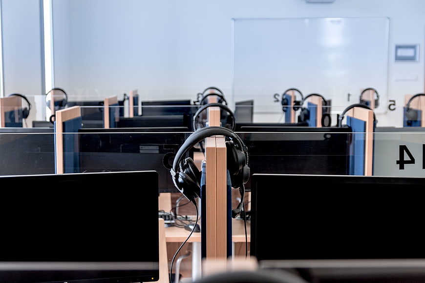 Modern Computer Lab with Headsets and Monitors