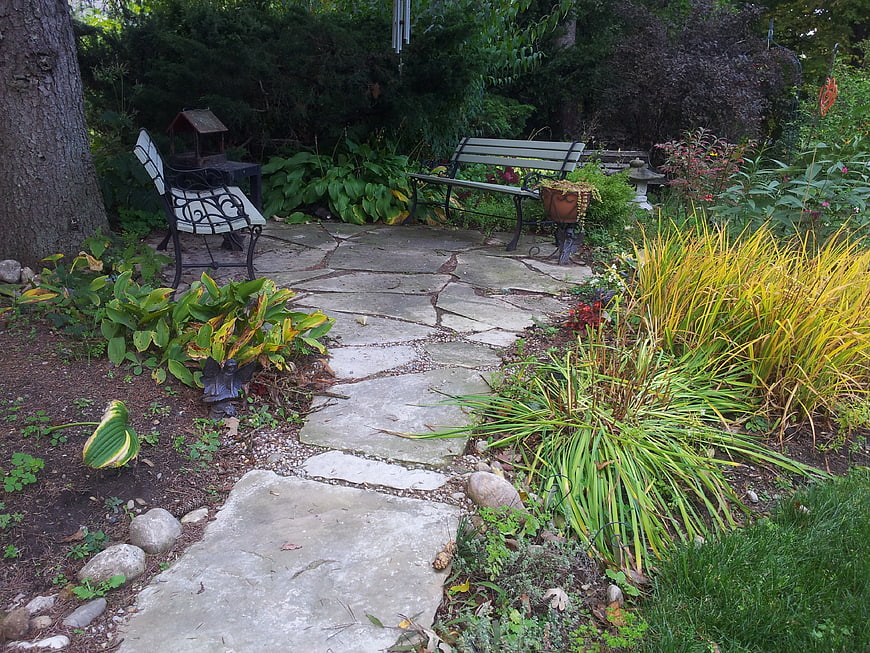 Peaceful Garden Patio with Stone Path and Benches