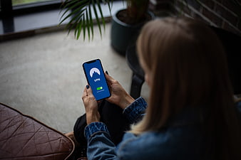 Woman using VPN app on smartphone for internet security