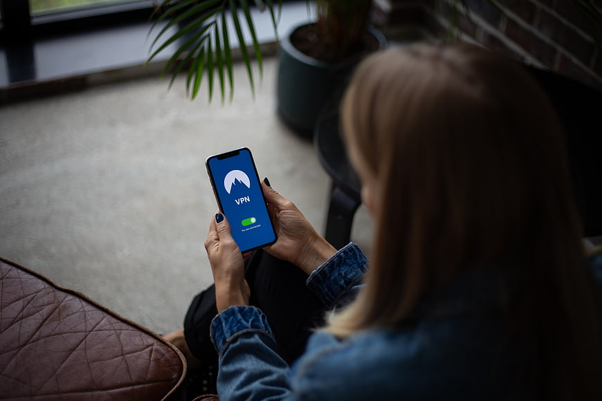 Woman using VPN app on smartphone for internet security
