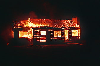House Enveloped In Flames At Night