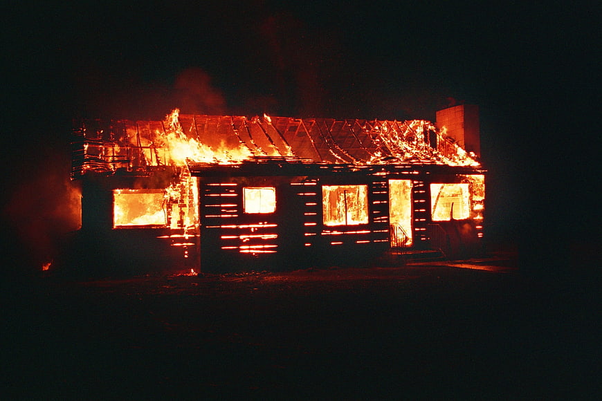 House Enveloped In Flames At Night